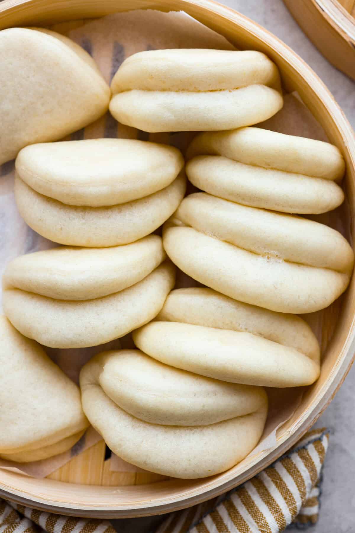 Overhead shot of bao buns in a bamboo steamer.