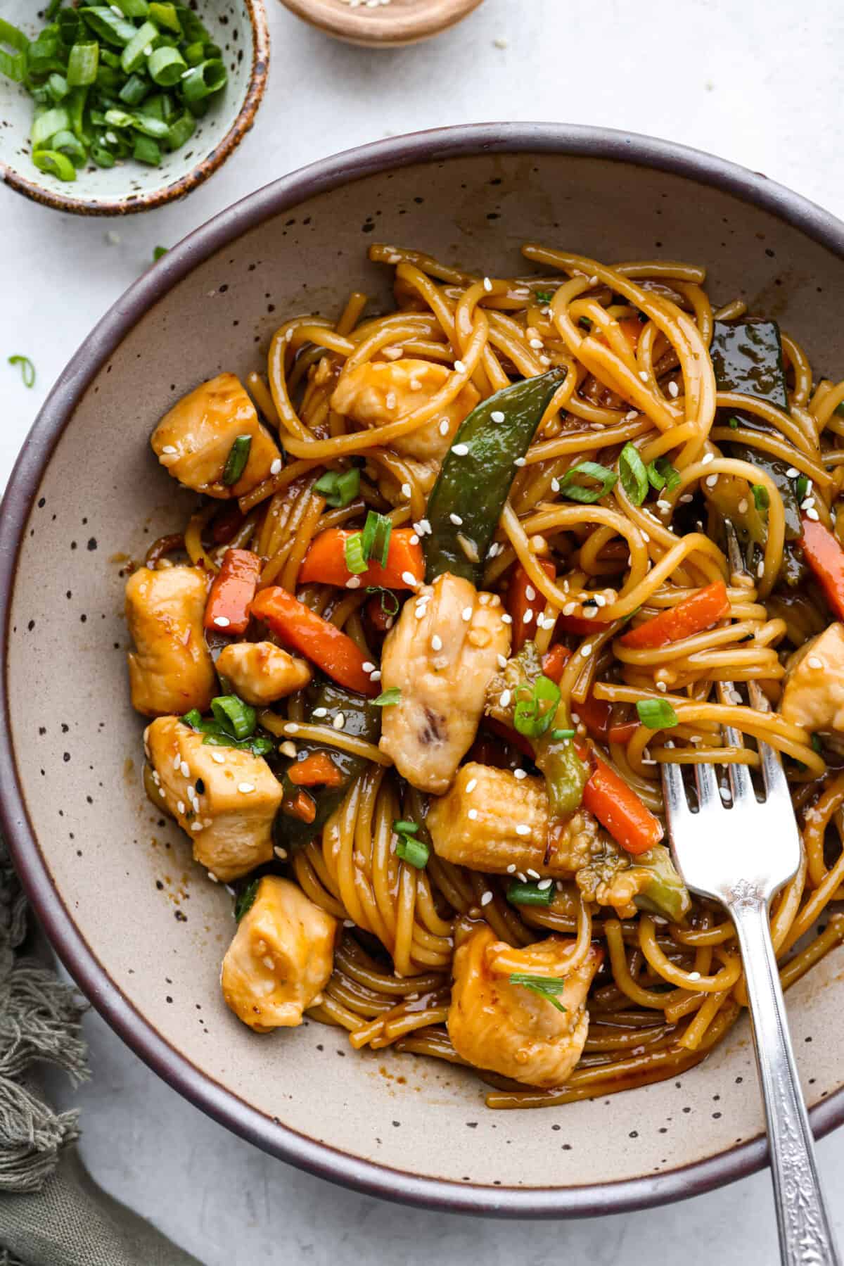 Overhead shot of plated honey sesame chicken noodle bake. 