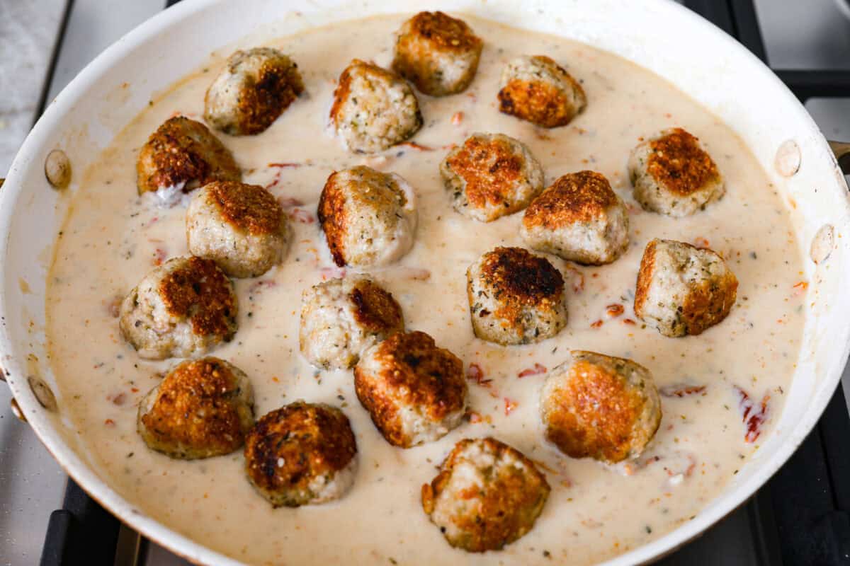 Overhead shot of the meatballs added back to the pan.