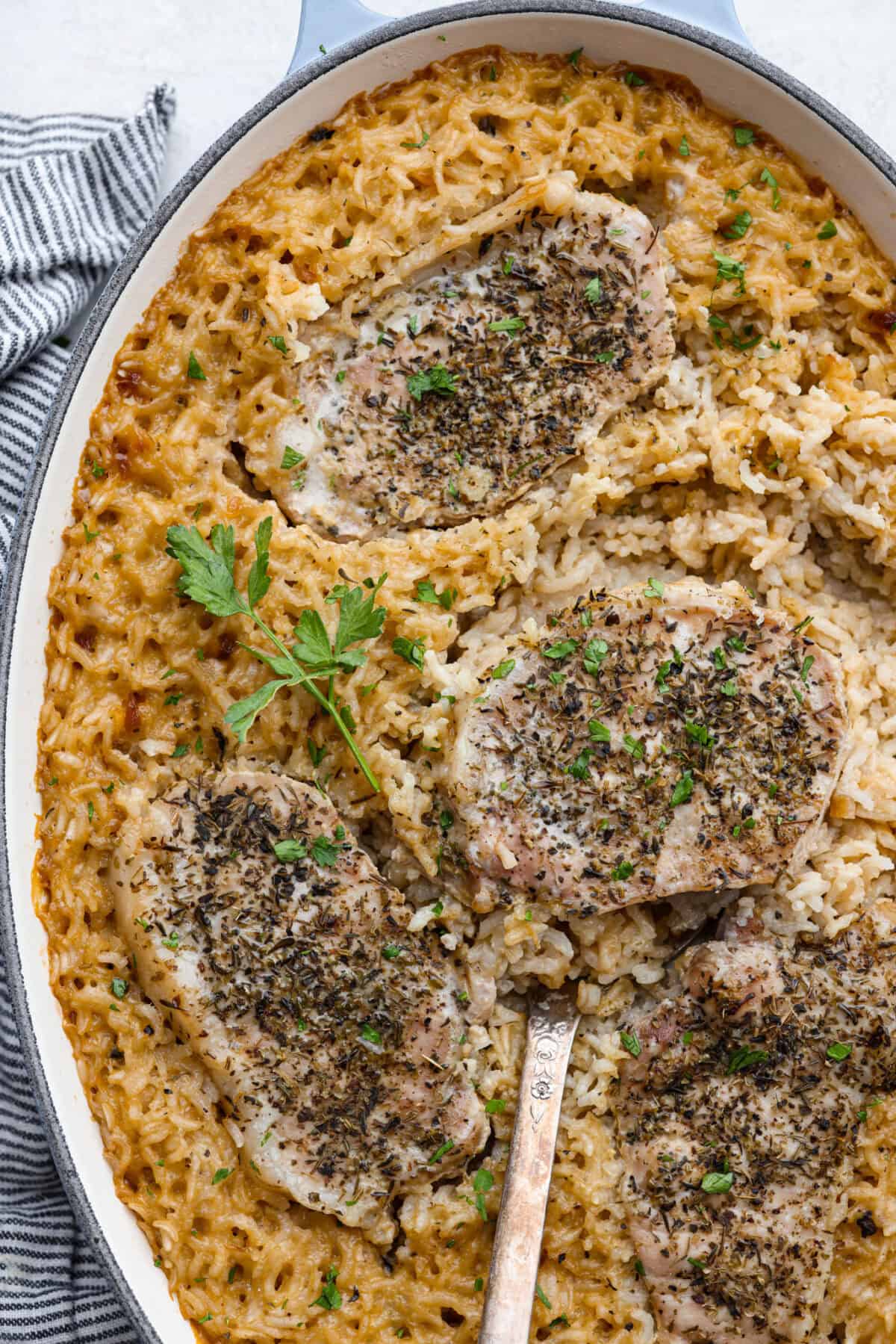 Overhead shot of no peek pork chops and rice in a baking dish. 