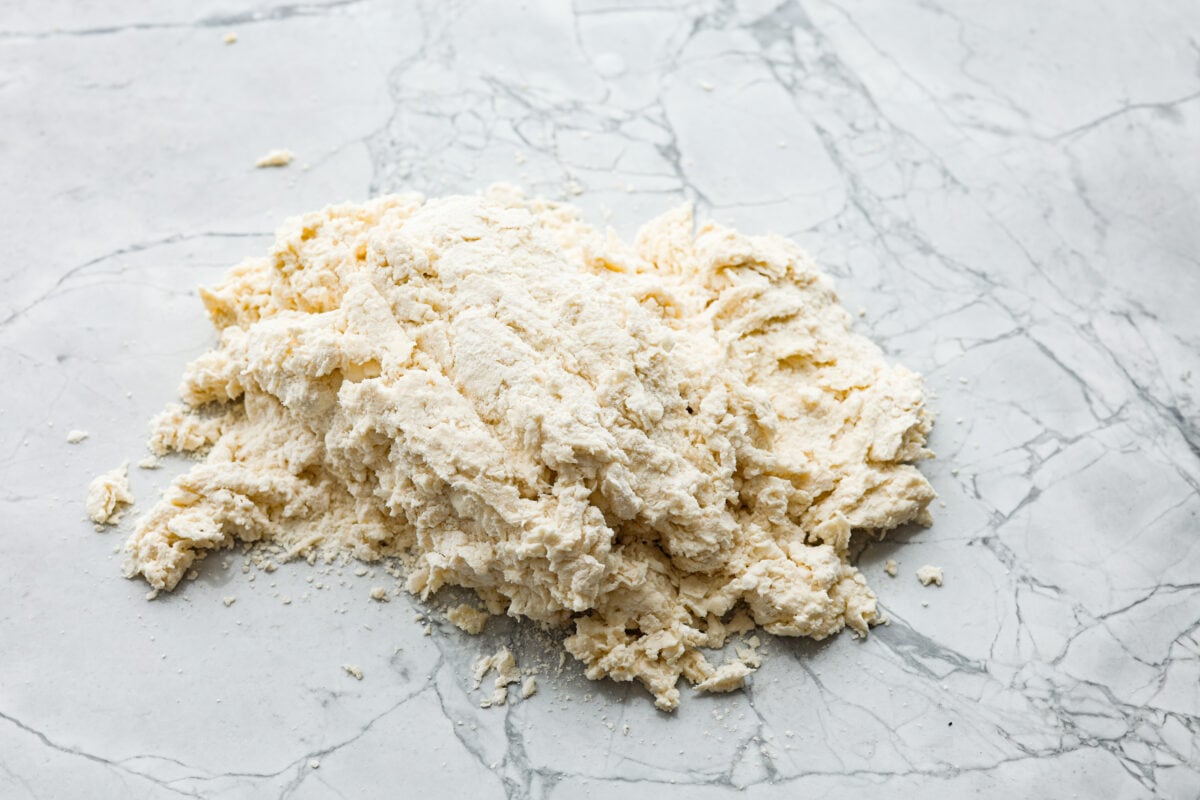 Overhead shot of flour, butter and buttermilk mixture on a countertop. 