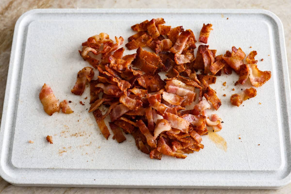 Overhead shot of cooked bacon on a cutting board. 