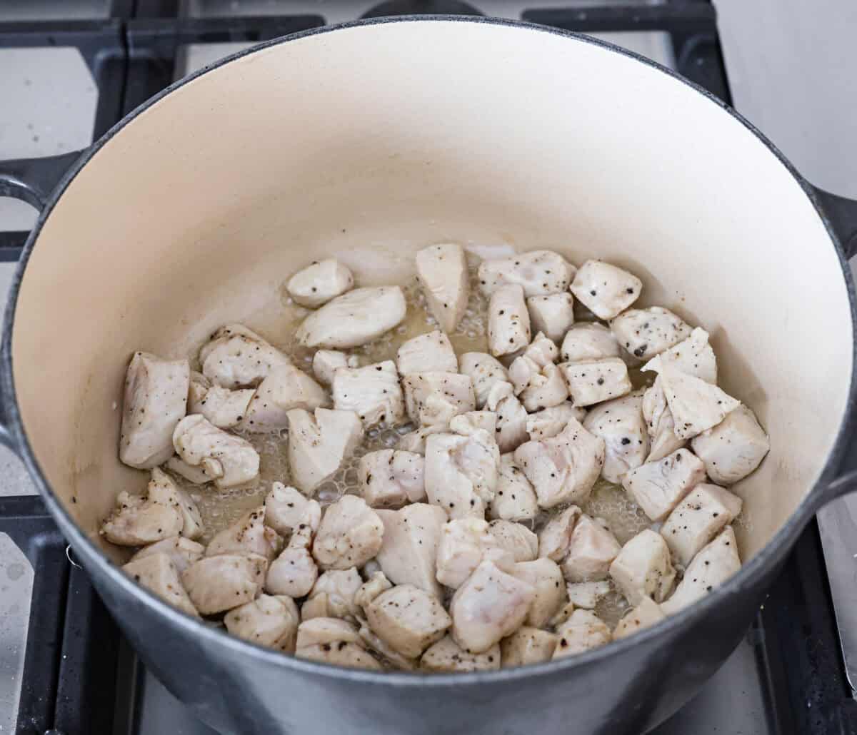 Overhead shot of chicken cooking in a pot. 