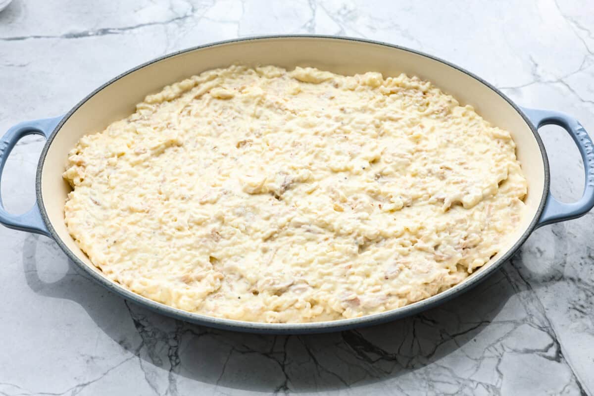 Overhead shot of the rice and cream sauce mixture in the bottom of a baking dish. 