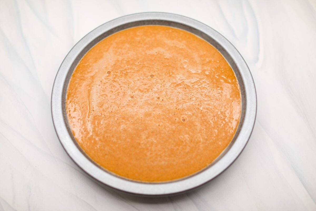 Overhead shot of pie pan with whisked ingredients inside it.