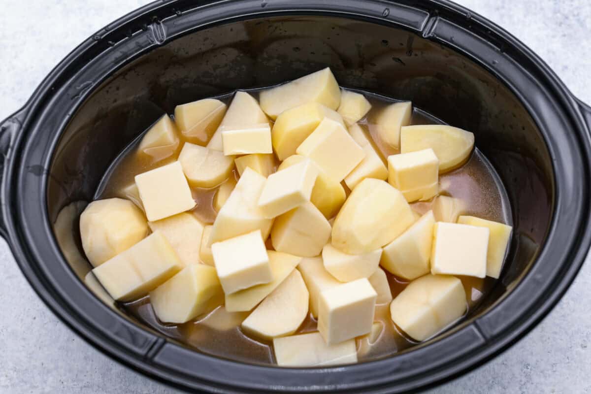 Overhead shot of cubed potatoes in crockpot.