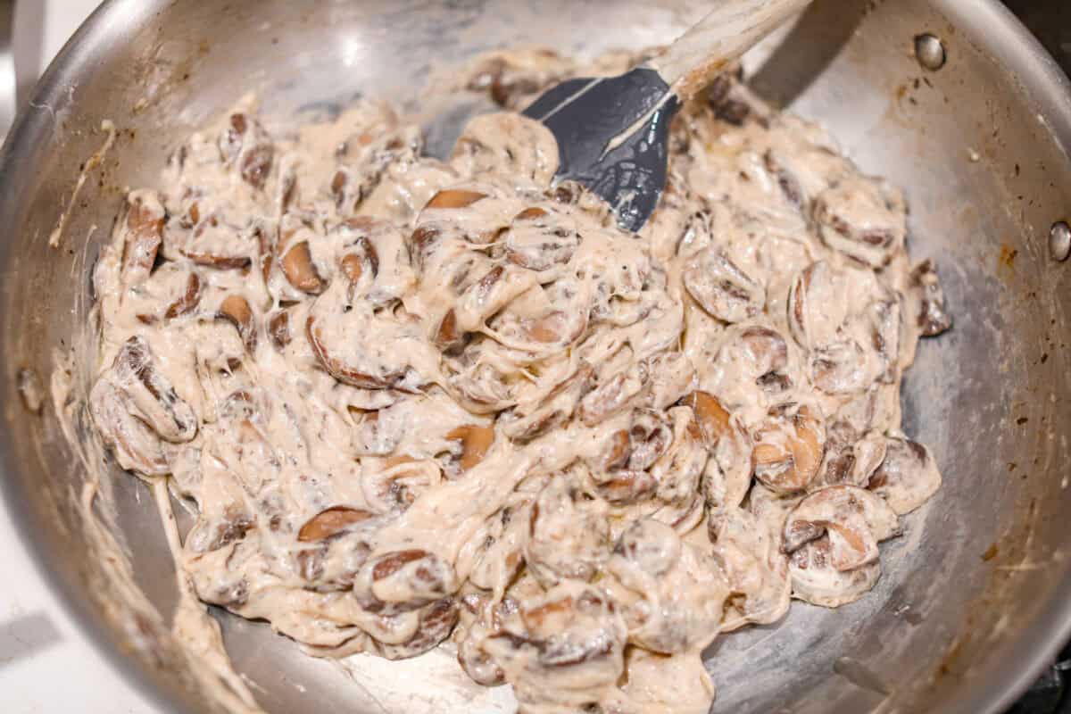 Fourth photo of the mushrooms stirred into the creamy mixture.