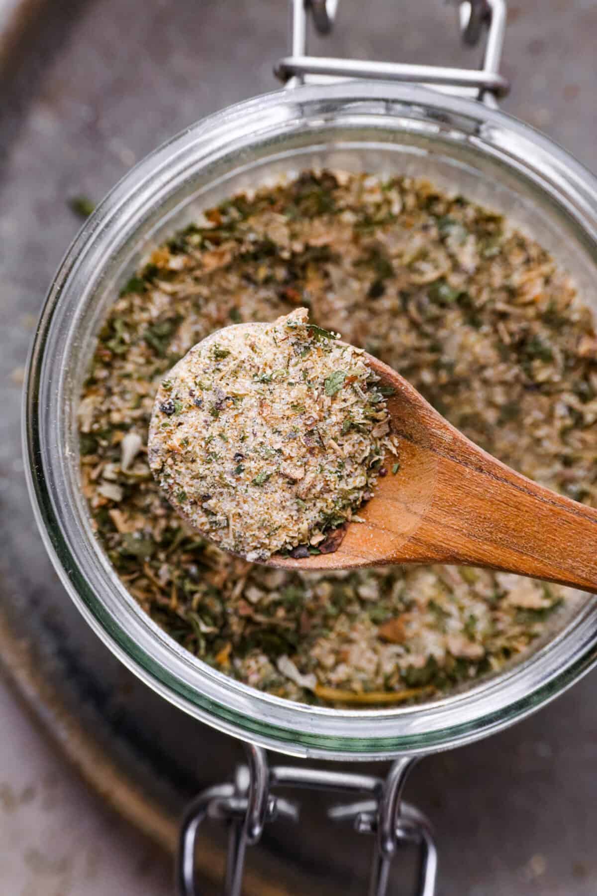 Close up shot of a spoonful of homemade garlic herb seasoning.