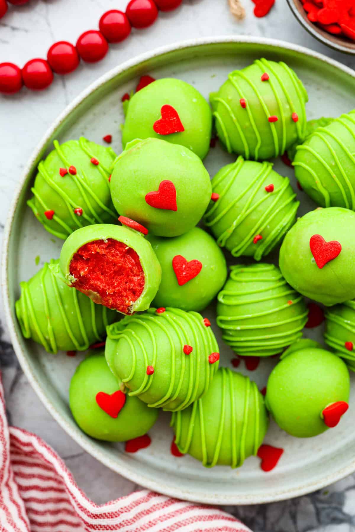 Overhead shot of Grinch Oreo balls on a serving platter. 