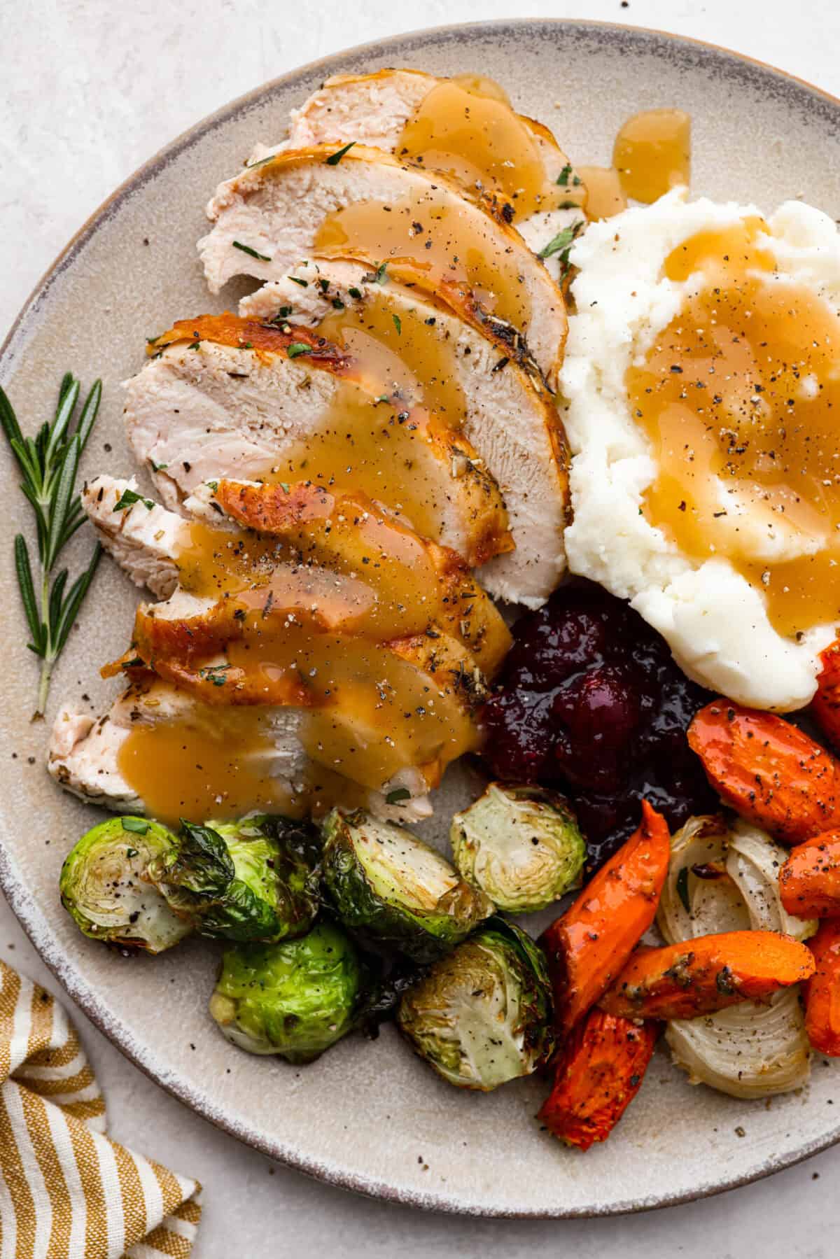 Top view of Thanksgiving dinner and oven roasted turkey on a plate.