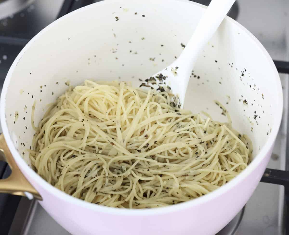 Angle shot of noodles mixed in with the butter garlic and seasoning. 