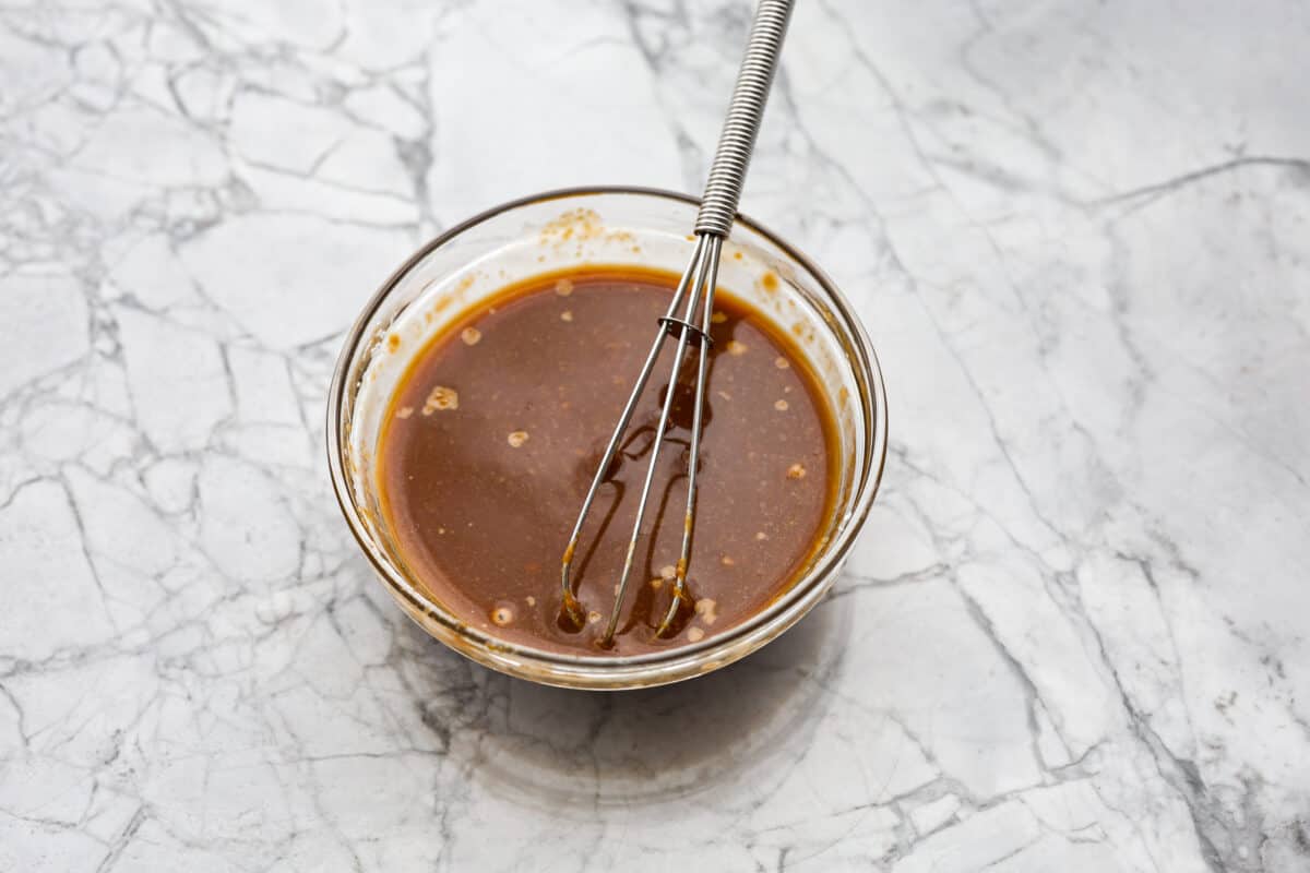 Overhead shot of sauce ingredients whisked together in a bowl. 