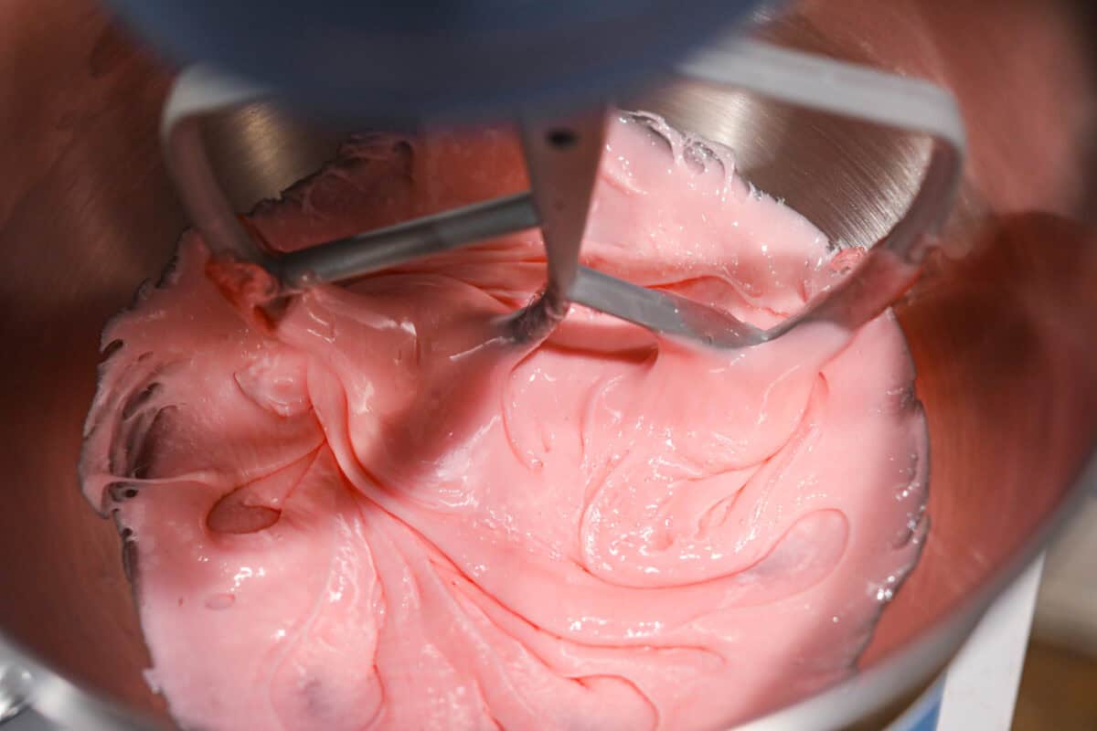 Close up shot of fondant being mixed in a stand mixer. 