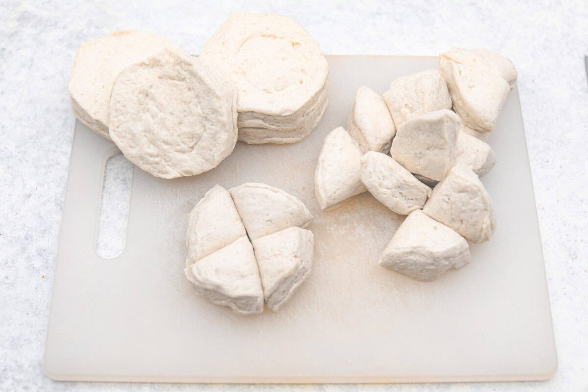 Overhead shot of cut up canned biscuit dough. 