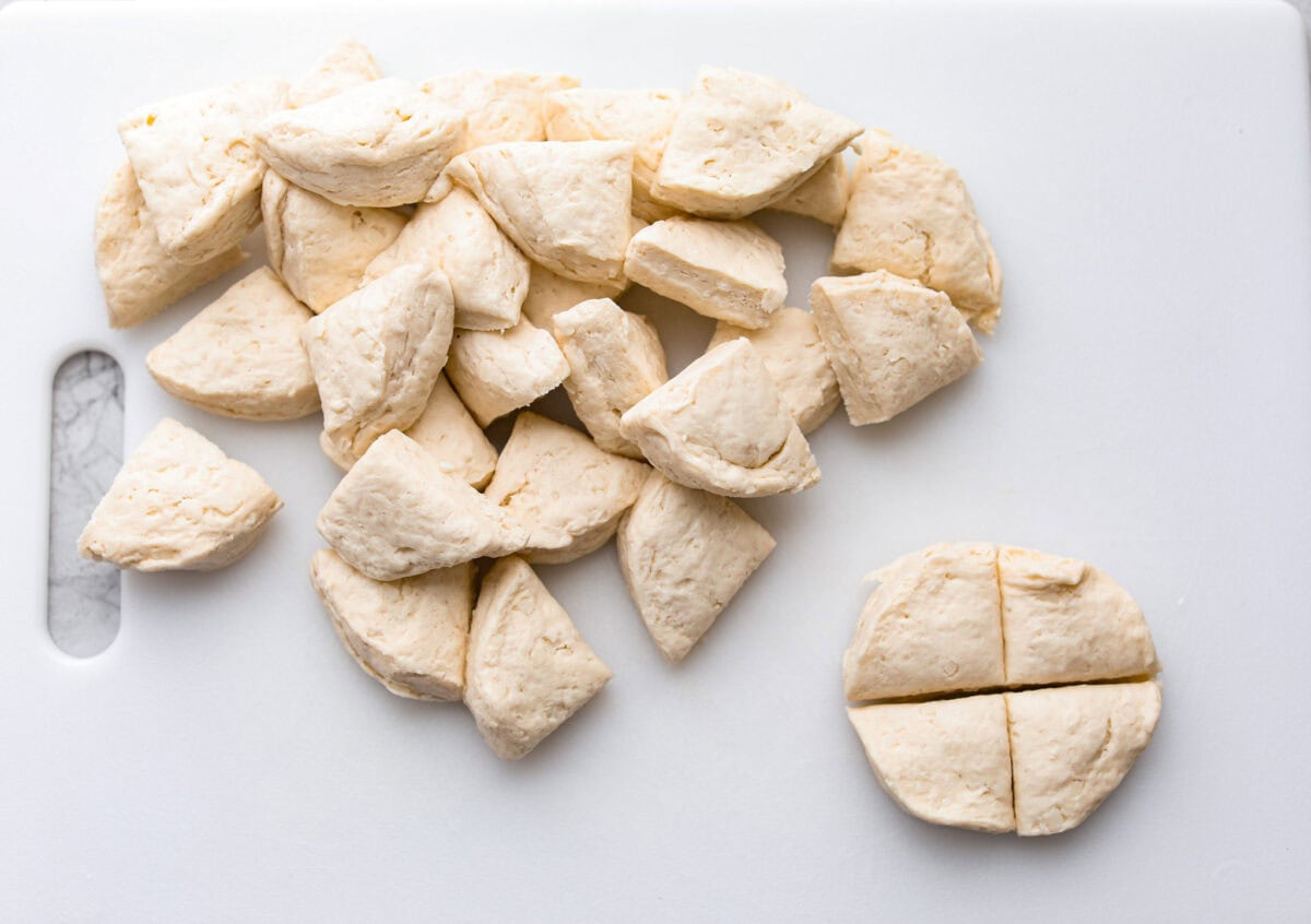 Overhead shot of canned biscuits cut into quarters. 