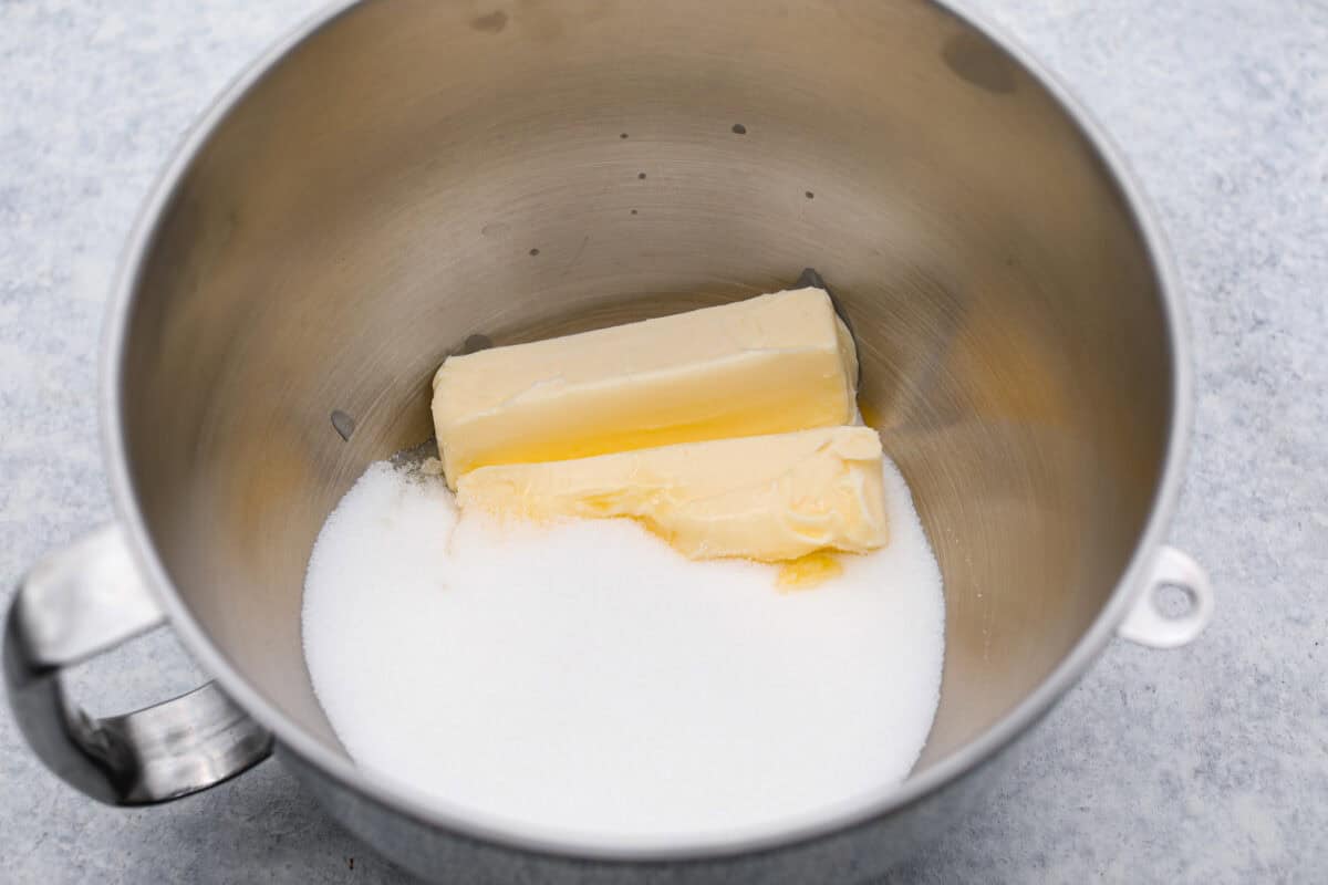 Overhead shot of butter and sugar in a mixing bowl. 