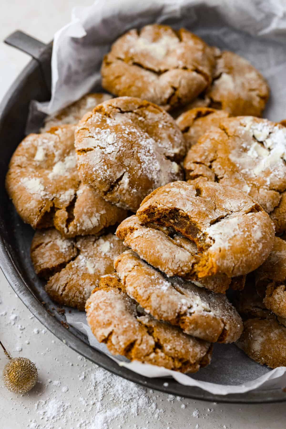 Close up shot of gingerbread crinkle cookies on a serving plate. 