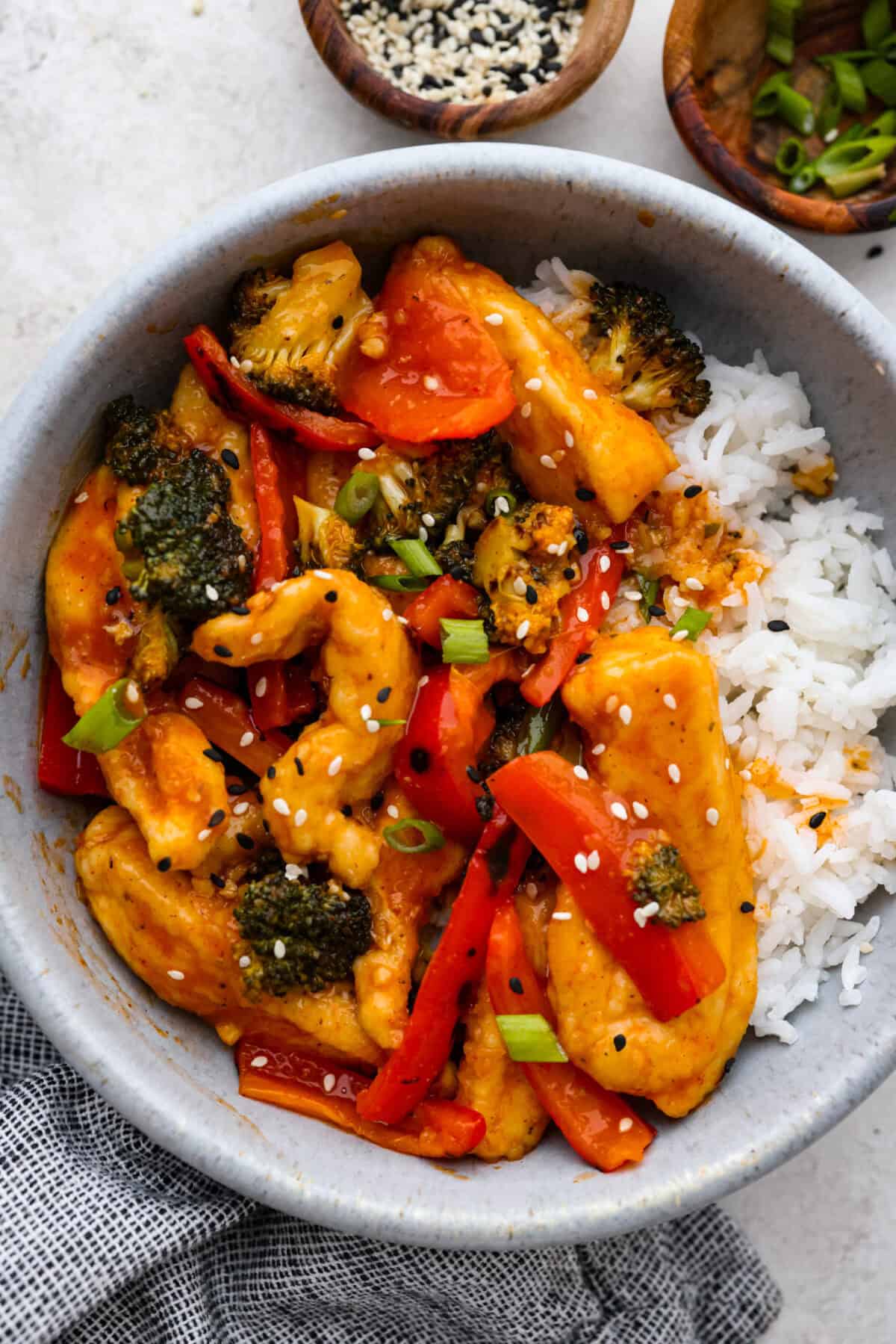 Close view of Hunan chicken in a bowl with rice.