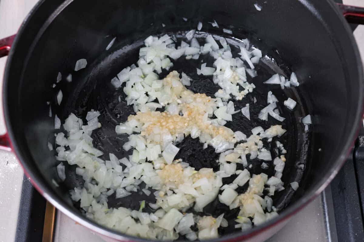 First photo of the onions and garlic sautéing in a pot.