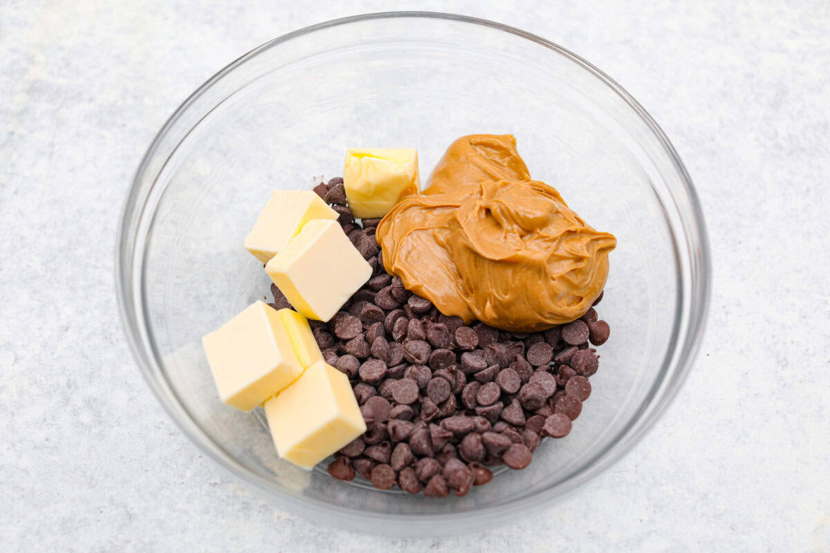 Overhead shot of butter, chocolate chips and peanut butter in a bowl. 