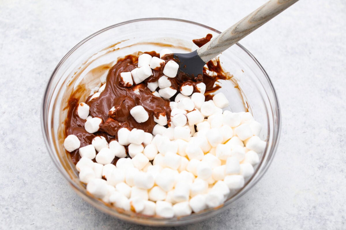 Overhead shot of mini marshmallows added to the melted peanut butter and chocolate mixture. 