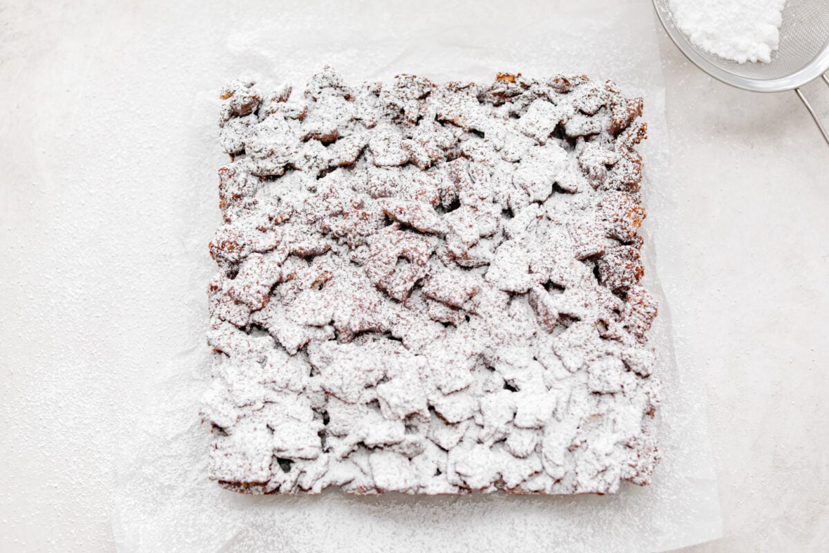 Overhead shot of muddy buddy bars dusted with powdered sugar. 