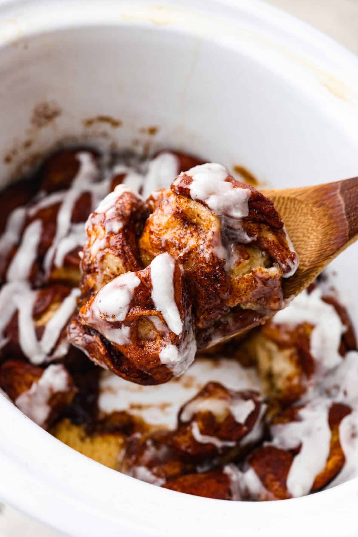 Close up shot of a scoop of crockpot monkey bread from the slow cooker. 