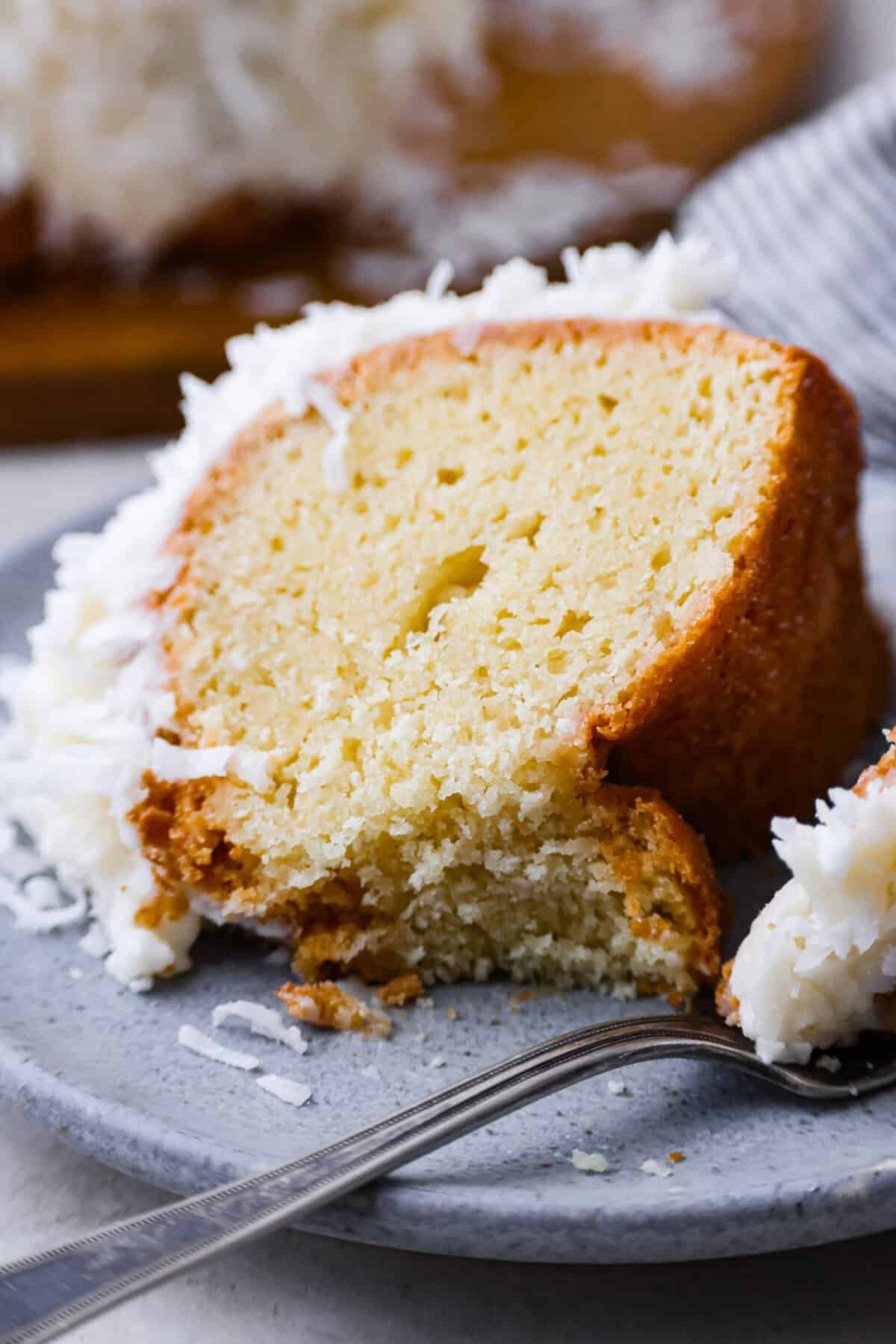 Close up shot of a piece of plated Tom Cruise coconut cake.