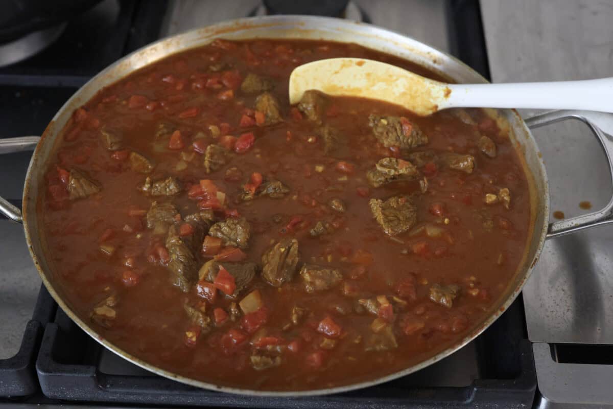 Angle shot of the finished dish simmering on the stove top. 