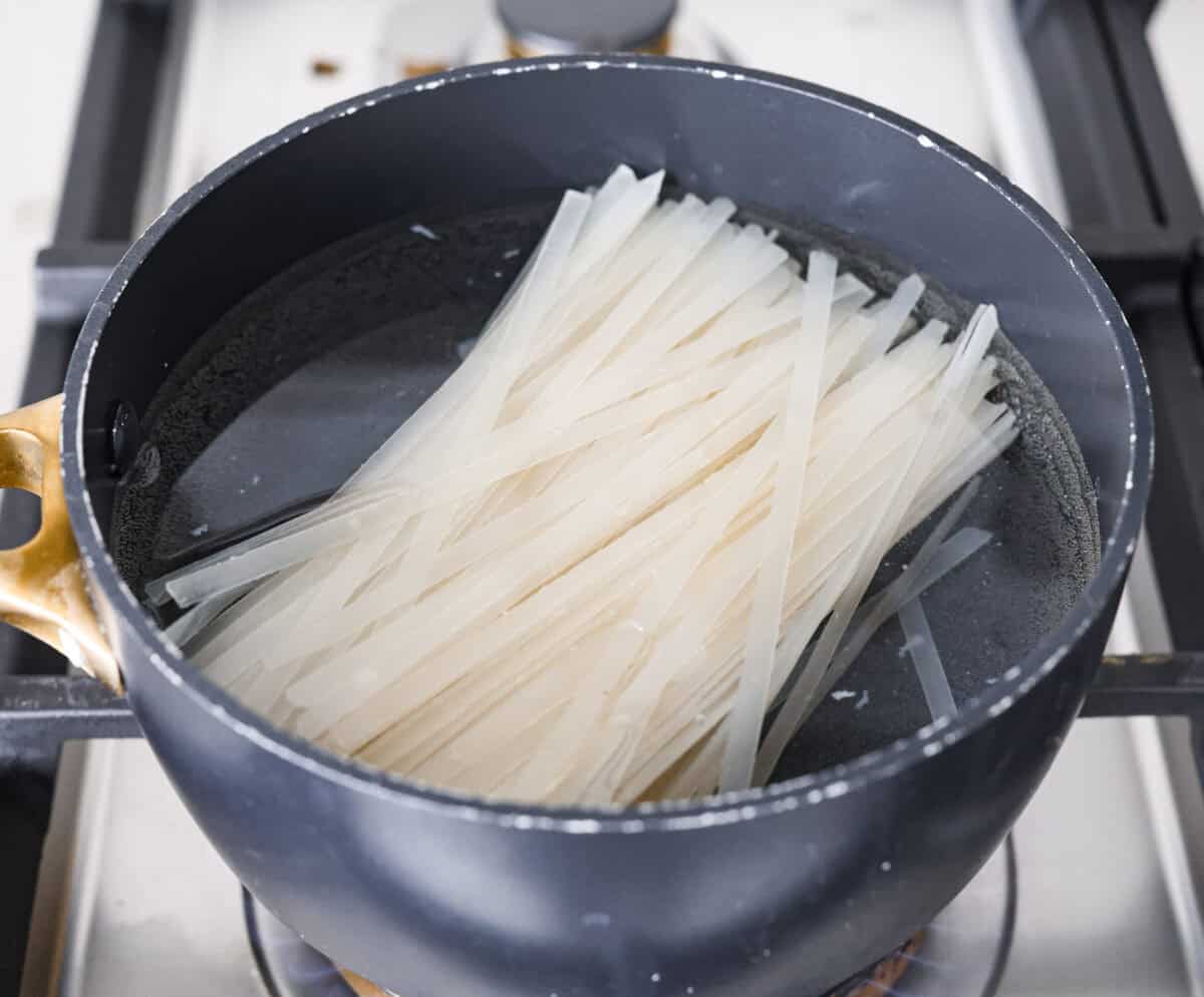 Overhead shot of the noodles boiling in a pot.