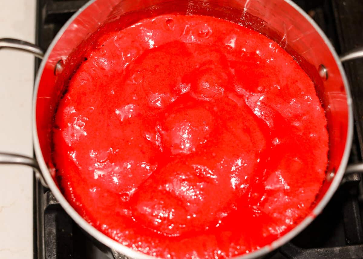 Overhead shot of the candy and butter mixture in a pot with baking soda added to it. 