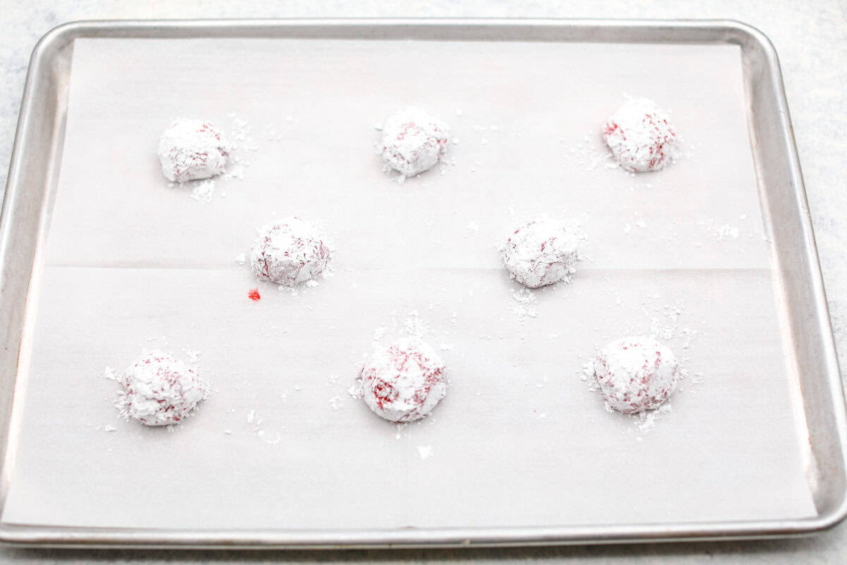 Angle shot of powdered cookie dough ready to be baked on the prepared baking sheet.