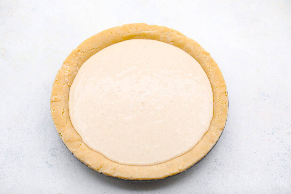 Overhead shot of the prepared pie crust filled with the ricotta filling. 