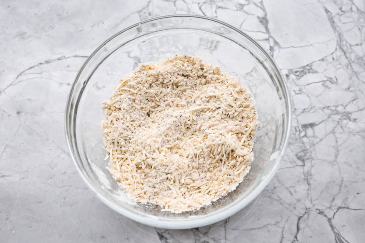 Overhead shot of breadcrumbs, parmesan cheese, and seasonings mixed in a bowl. 