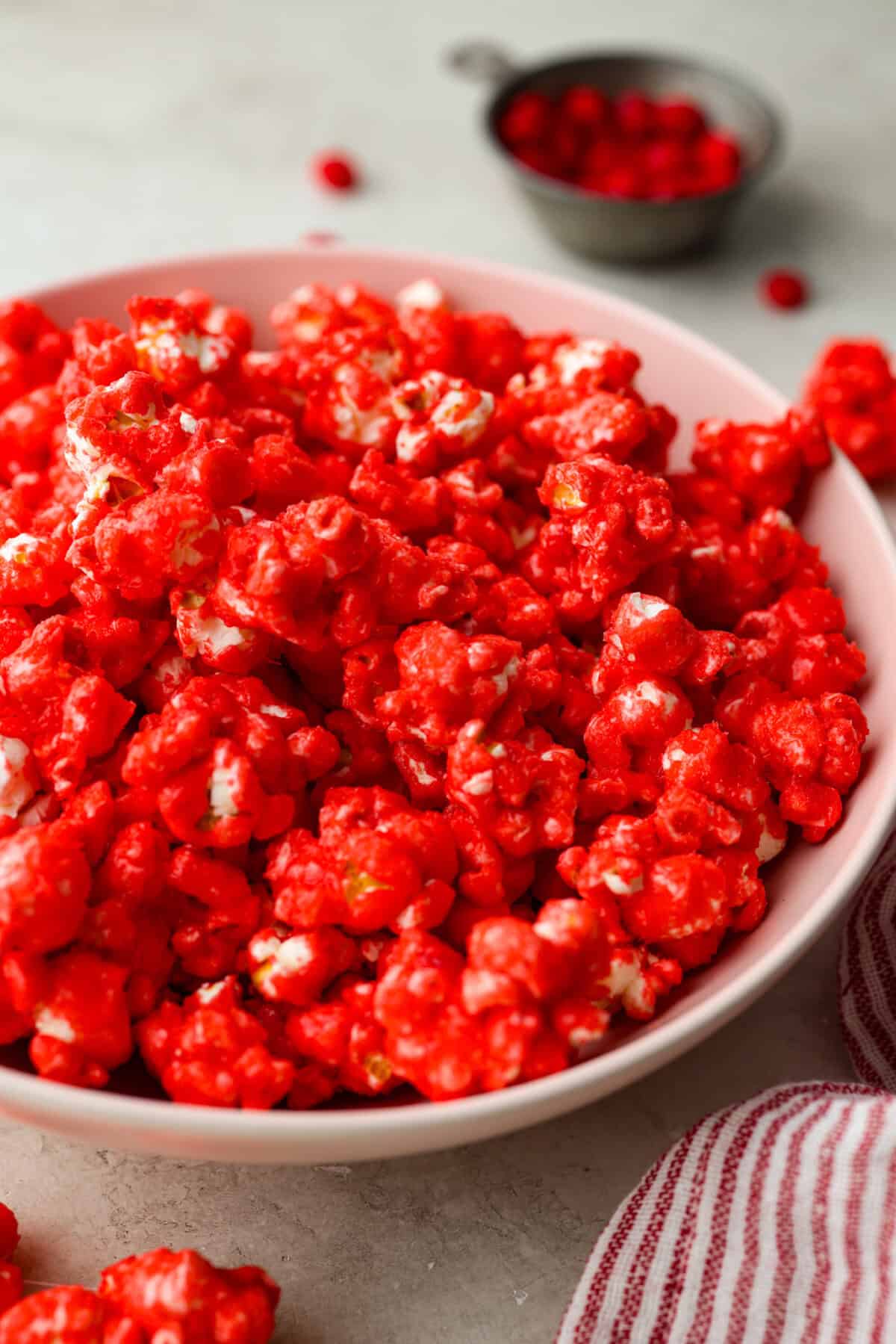 Angle shot of red hot cinnamon popcorn in a bowl. 