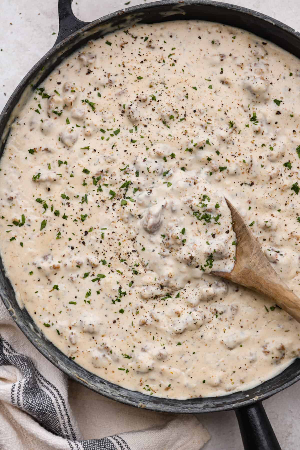 Overhead shot of sausage gravy in a large skillet. 