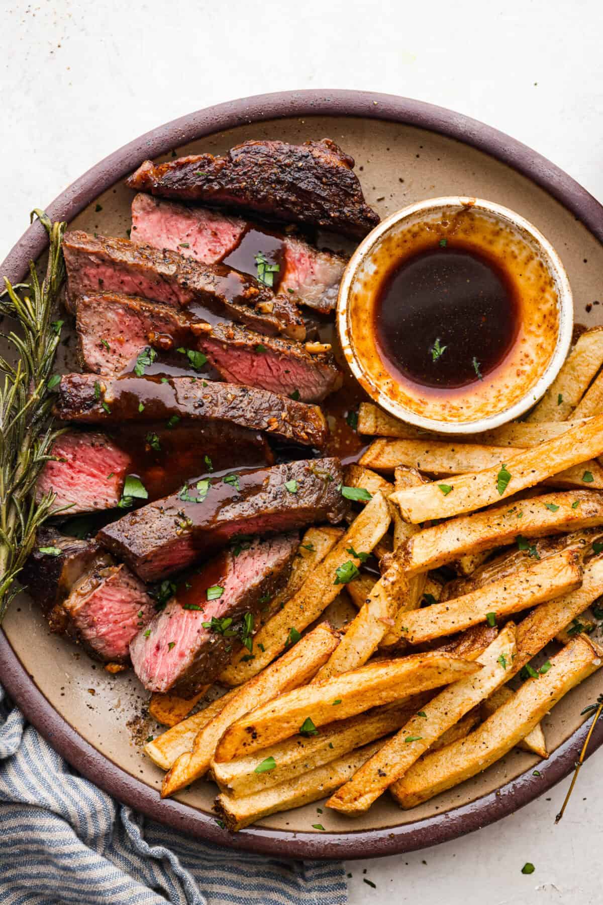 Overhead shot of plated and sliced steak frites. 