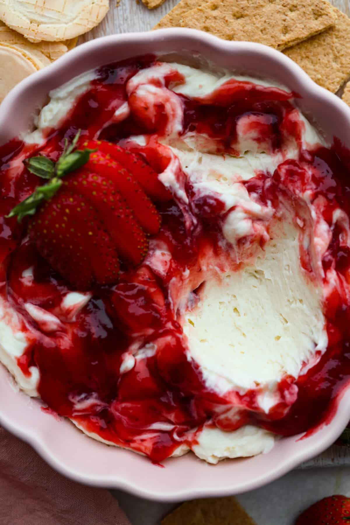 Close up shot of strawberry cheesecake dip in a serving dish. 