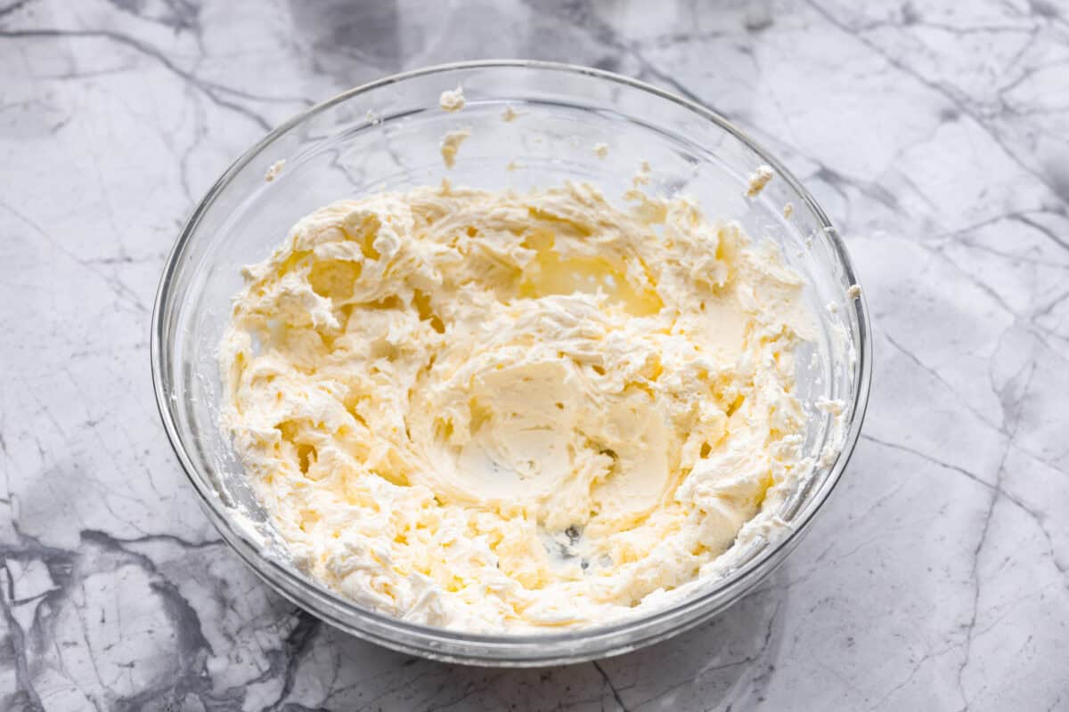 Overhead shot of cream cheese mixed in a bowl. 